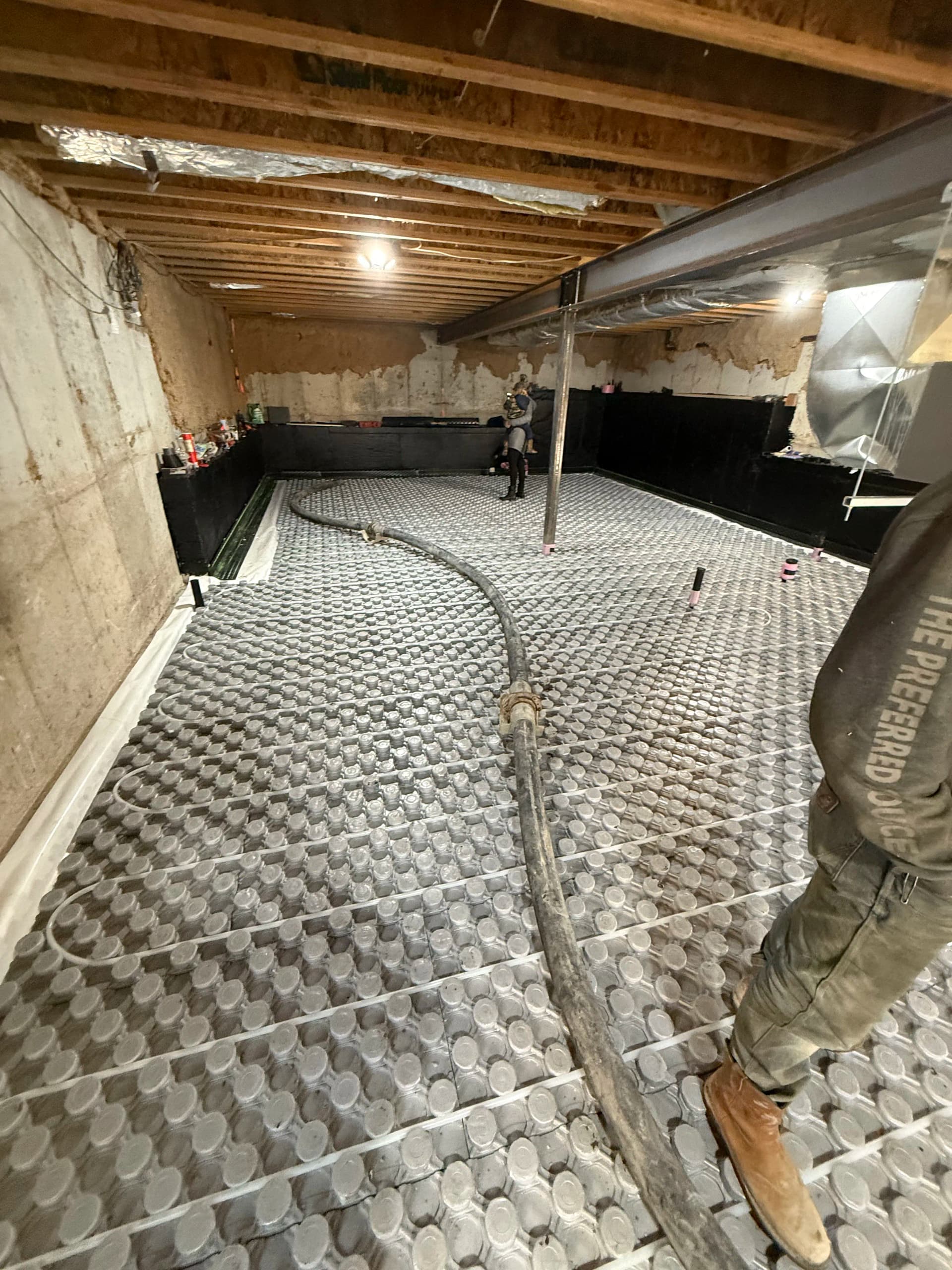 Basement Concrete Pour Using a Line Pump Through the Window image