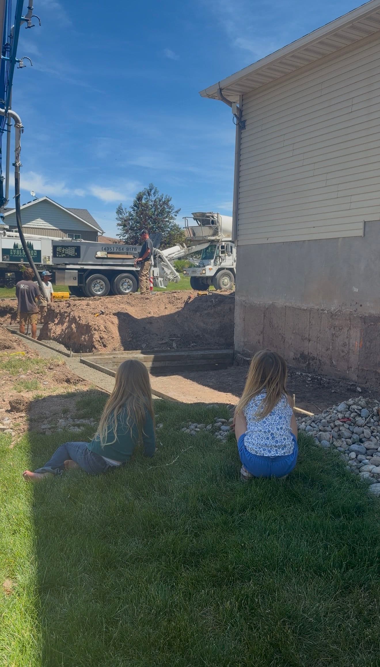Pouring Footings for a Home Addition With a Front Row Crowd image